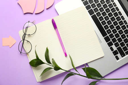 Composition with notebook and laptop on color background