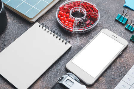 Notebooks with mobile phone on dark