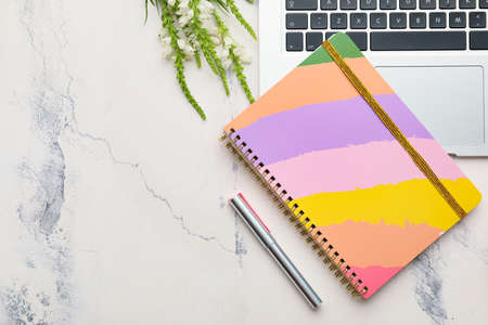Notebook with laptop on white background