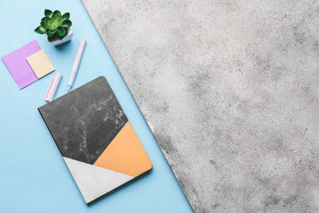 Composition with notebook on color background
