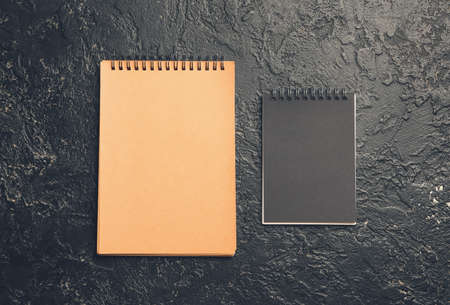 Different notebooks on dark background