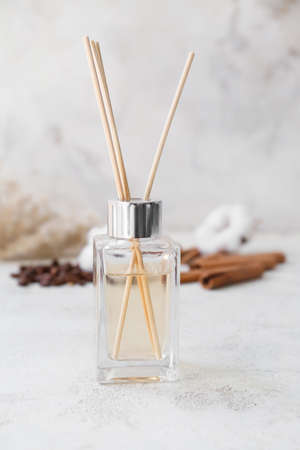 Reed diffuser, cotton, coffee beans and cinnamon on tableの写真素材