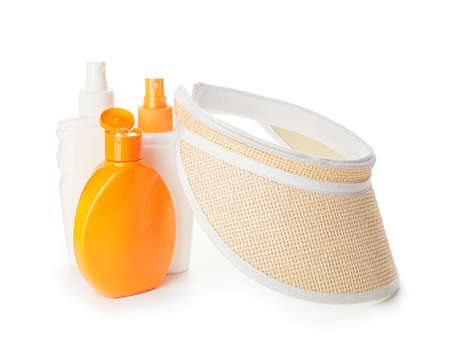 Bottles of sunscreen with hat on white background