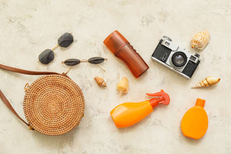 Travel accessories with sunscreen cream on light backgroundの写真素材
