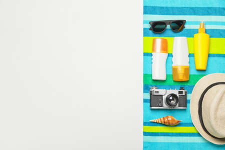 Beach accessories with sunscreen cream on white background