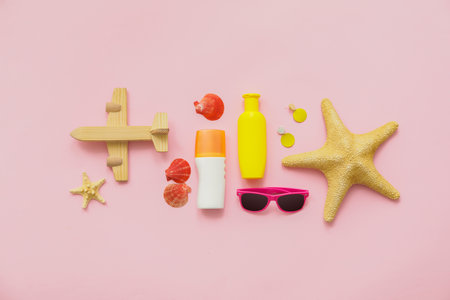 Travel accessories with sunscreen cream on color backgroundの写真素材