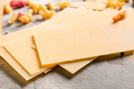 Dry lasagna sheets on grunge backgroundの写真素材