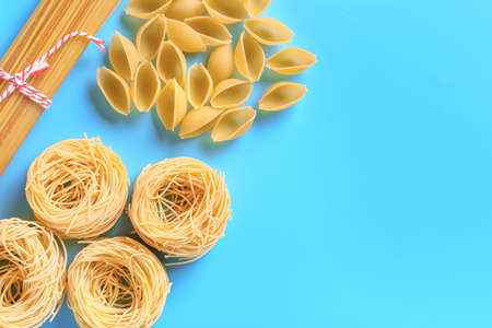 Assortment of dry pasta on color backgroundの写真素材