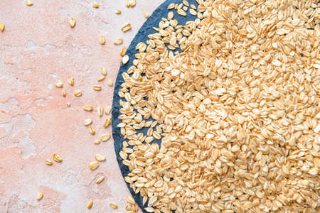 Plate with raw oatmeal on table