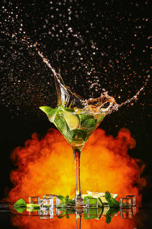 Glass of fresh mojito with splash on dark backgroundの写真素材