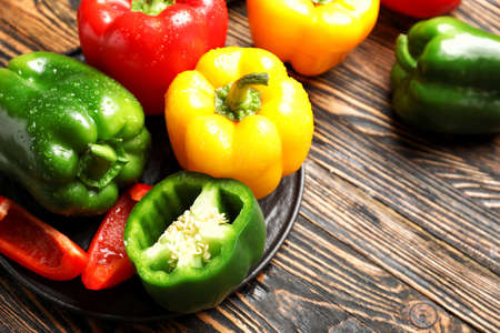 Fresh bell peppers on wooden backgroundの写真素材