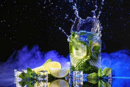 Glass of fresh mojito with splash on dark backgroundの写真素材