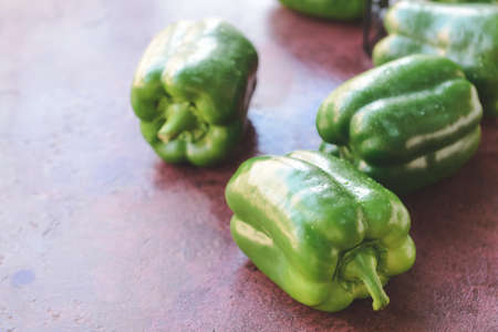 Green bell pepper on tableの写真素材
