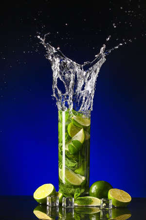Glass of fresh mojito with splash on dark backgroundの写真素材