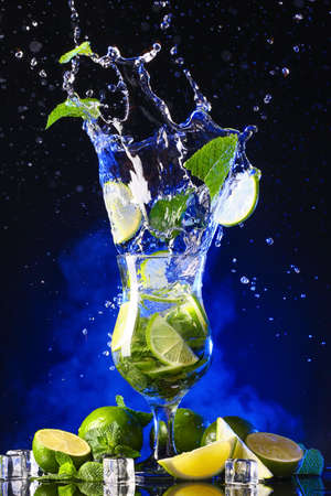 Glass of fresh mojito with splash on dark backgroundの写真素材