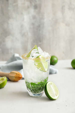 Glass of fresh mojito on table
