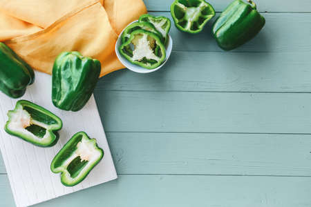 Green bell pepper on wooden tableの写真素材