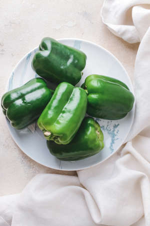 Plate with green bell pepper on tableの写真素材