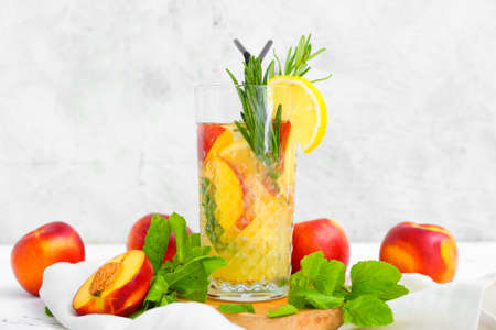 Glass of fresh peach lemonade on tableの写真素材