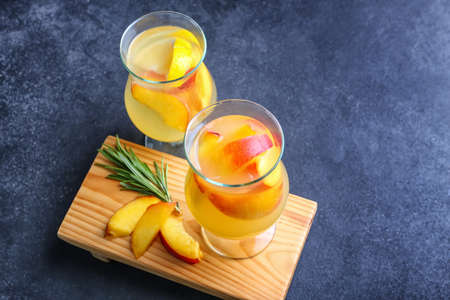 Glasses of fresh peach lemonade on tableの写真素材