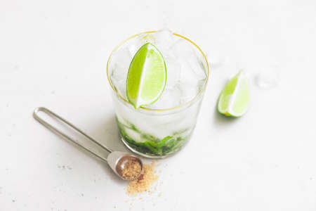 Glass of fresh mojito on table