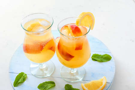 Glasses of fresh peach lemonade on tableの写真素材