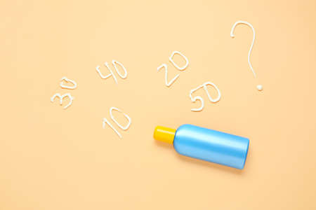 Bottle of sunscreen on color background