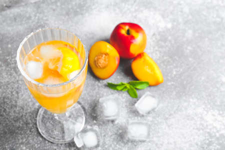 Glass of fresh peach lemonade on tableの写真素材