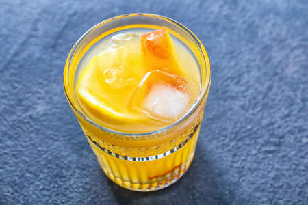 Glass of fresh peach lemonade on tableの写真素材