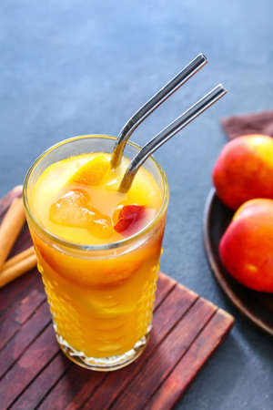 Glass of fresh peach lemonade on tableの写真素材
