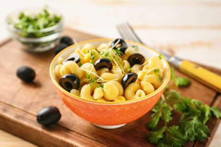 Bowl with tasty pasta salad on tableの写真素材