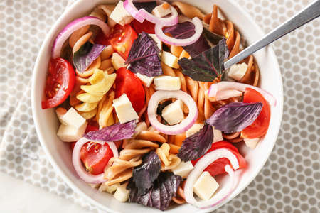 Bowl with tasty pasta salad on table, closeupの写真素材