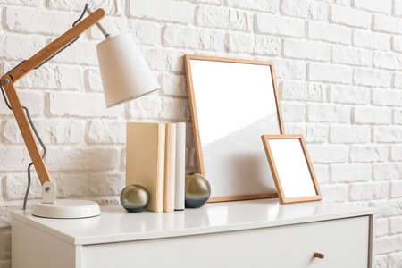 Modern chest of drawers near brick wallの写真素材