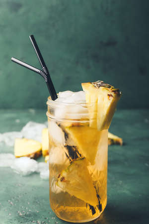 Glass of fresh pineapple mojito cocktail on table