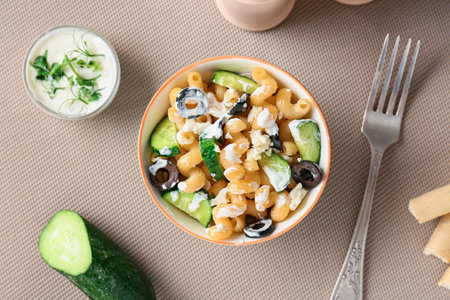 Bowl with tasty pasta salad on tableの写真素材