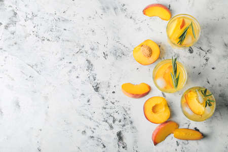 Glasses of fresh peach mojito cocktail on tableの写真素材