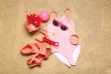 Set of beach accessories for children on sand, top viewの写真素材