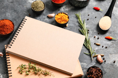 Notebooks for recipes and spices on gray backgroundの写真素材