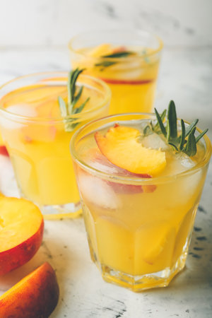 Glasses of fresh peach mojito cocktail on tableの写真素材