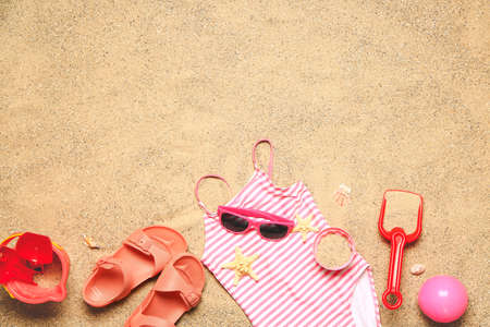 Set of beach accessories for children on sand, top viewの写真素材
