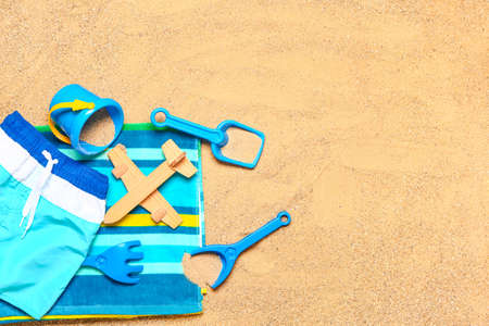 Set of beach accessories for children on sand, top viewの写真素材