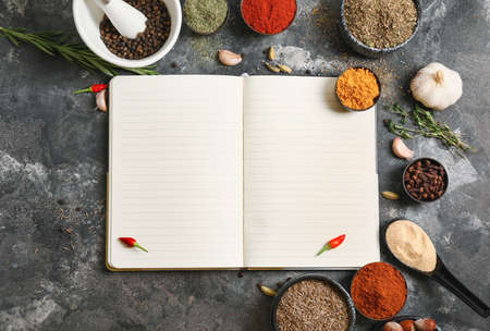Notebook for recipes and spices on gray backgroundの写真素材