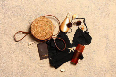 Set of beach accessories on sand, top viewの写真素材