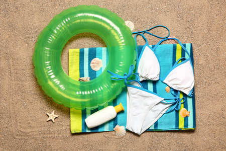 Set of beach accessories on sand, top viewの写真素材