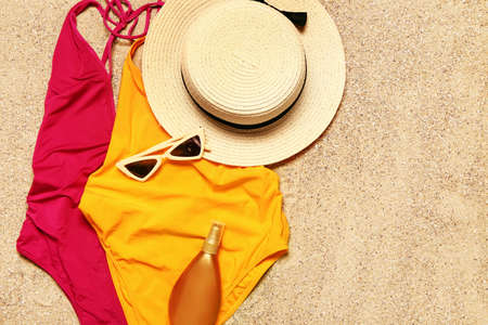 Set of beach accessories on sand, top viewの写真素材