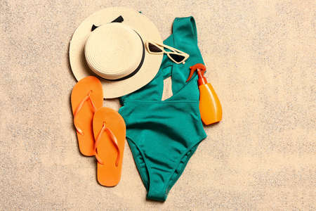 Set of beach accessories on sand, top viewの写真素材
