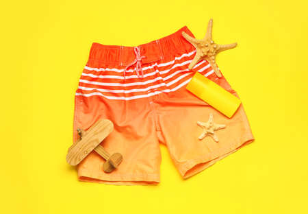Set of beach accessories for children on color background