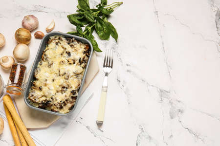 Baking dish with tasty rice casserole on white backgroundの写真素材