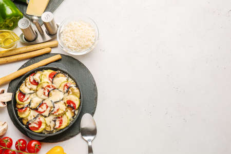 Baking dish with tasty rice casserole on white backgroundの写真素材