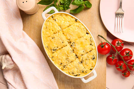 Baking dish with tasty rice casserole on tableの写真素材